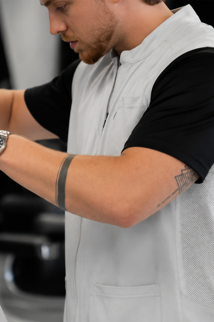The Barber Vest in Cool Gray, side view showing the mesh side panel