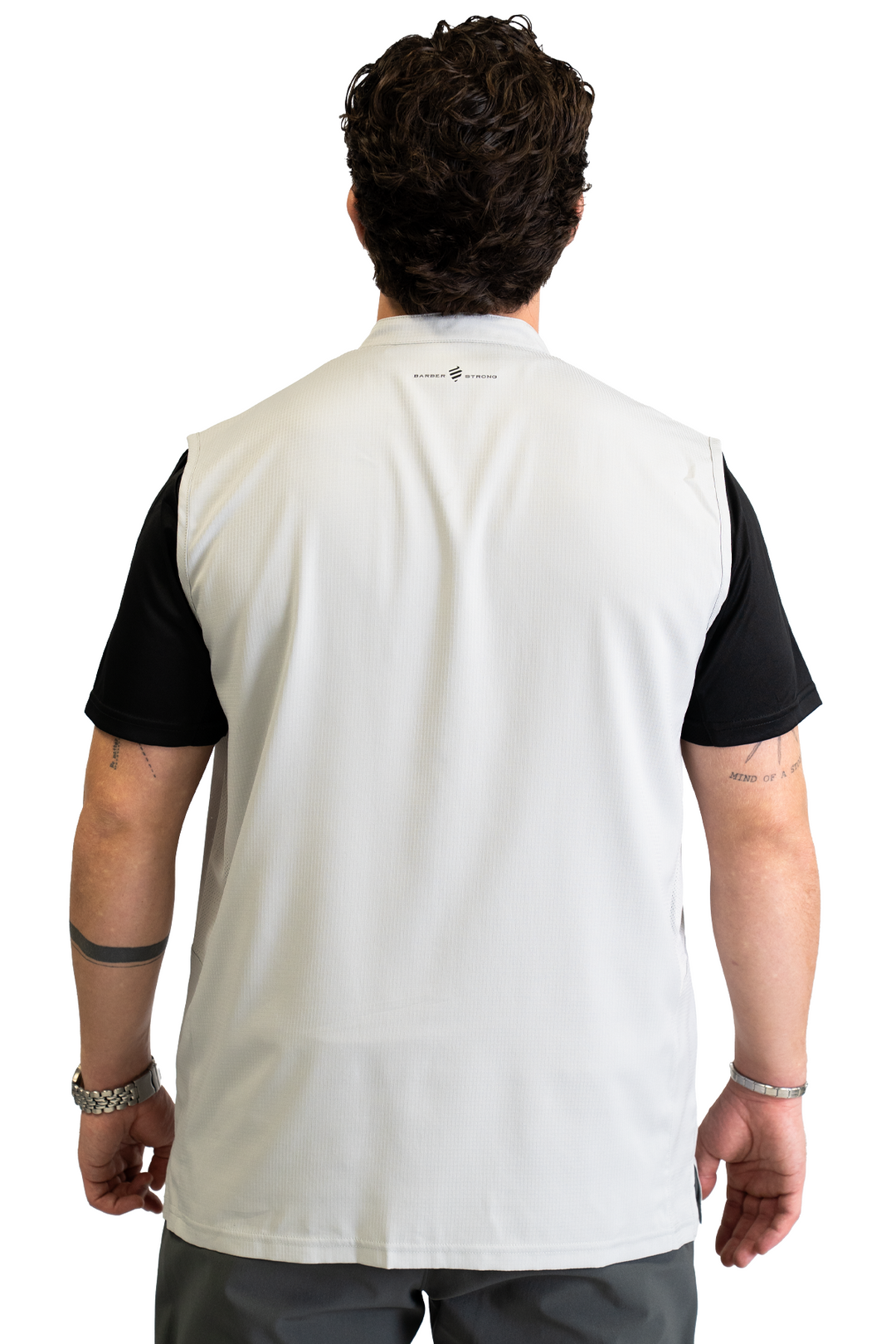The Barber Vest in Cool Gray, back view with the Barber Strong logo below the collar