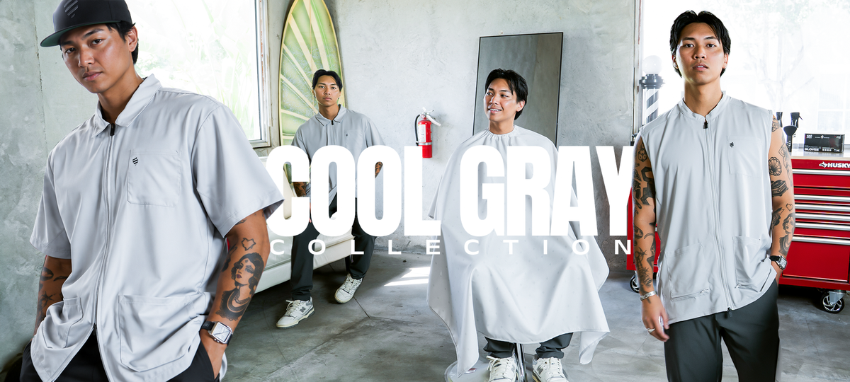 Shop the Cool Gray Collection. Barbers wearing The Barber Jacket and The Barber Vest in Cool Gray, with a client in the Cool Gray Shield Barber Cape.