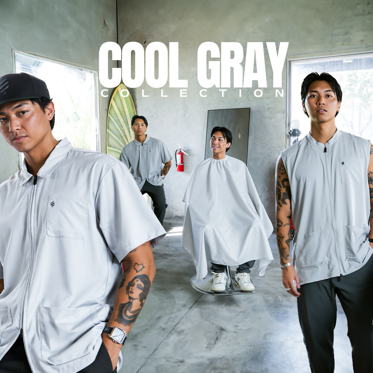 Shop the Cool Gray Collection. Barbers wearing The Barber Jacket and The Barber Vest in Cool Gray, with a client in the Cool Gray Shield Barber Cape.
